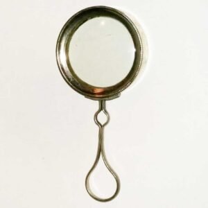 Antique minifying glass circa 1890, chrome-plated brass with concave lens, loop handle, marked Made in France, shown beside a US nickel for scale