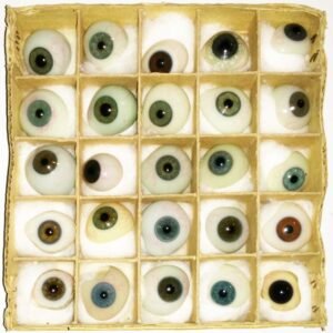 Collection of antique c.1900 hand blown prosthetic glass eyes in various sizes and iris colors by J. Janicot of Bagnolet Paris, displayed in original corrugated cardboard box
