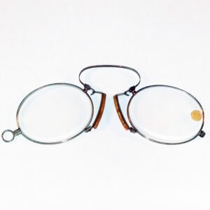 Antique c.1880 cork and steel pince-nez with slender oval steel rims, tortoiseshell-toned cork nose pads, and original +2.75 diopter lenses, new old stock never worn