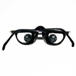 Antique 1955 Keeler surgical loupes with telescopic lenses and black spectacle frame, mid-20th century ophthalmic surgery magnification instrument named to Dr. Sanders A. Goodman