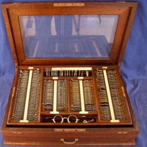 Complete 342-lens spherocylinder trial lens set in original mahogany case with glass window lid, 59x37x15cm antique ophthalmic refraction instrument