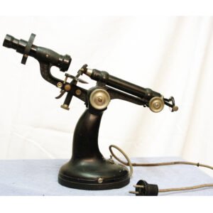 Antique Italian lensmeter c.1945–1955 with cast iron telephone-style base and brass optical head, used to measure spectacle lens and glasses power