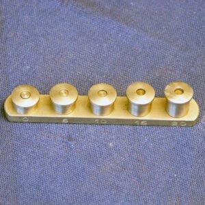 Calibration bank for Schiotz tonometer with row of precision brass and silver test balls on brass rail, antique glaucoma diagnostic instrument accessory