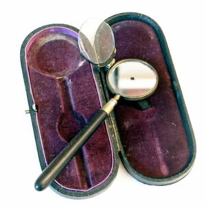 Eperon style antique ophthalmoscope with circular mirror aperture and 2.5-diopter swivel lens, presented in original fitted burgundy velvet case, manufactured by Pfister and Streit, Bern