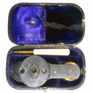 Antique 1882 Juler ophthalmoscope marked Curry & Paxton London, with 24-lens disc and rotatable mirror arm, presented in original fitted case with blue velvet lining