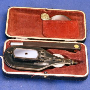 Antique 1890 Knauer's ophthalmoscope with dual lens disc system, concave and plane mirrors, and +13 diopter accessory lens, presented in original fitted red velvet case
