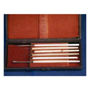 Antique 19th century eye surgery instrument set with ivory-handled ophthalmic surgical tools in original fitted wooden case with red velvet lining